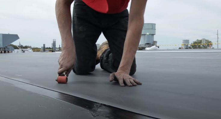 Coquitlam Roofer with mini roller applicator